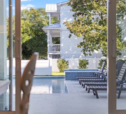 Double sliding glass doors overlooking the pool and back yard