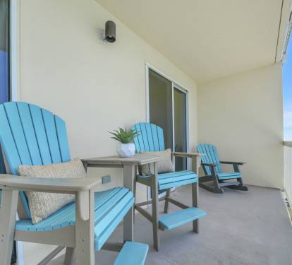 Relax on the balcony with seating designed for the view—two elevated Polywood chairs with a connecting table let you see right over the railing, while two Polywood rockers offer the perfect spot to unwind to the sound of the waves.