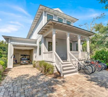Front of house with parking for 3 vehicles.  A 6 seater golf cart and 8 full size bikes