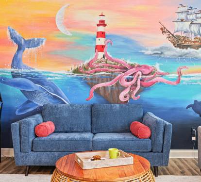 Kick back under the whimsical ocean mural with Pac-Man ready to play
