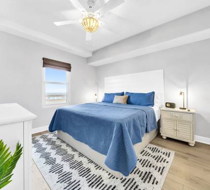 A serene second king suite with soft coastal touches and its own en suite bath—perfect for relaxing after a day at the beach.