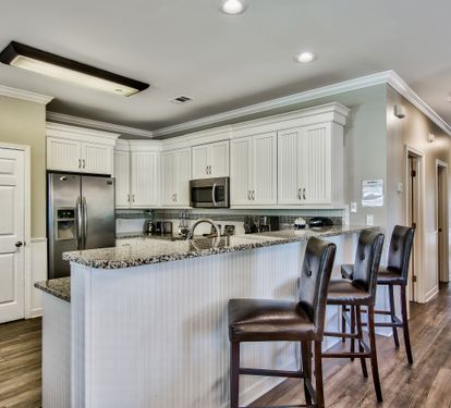 Fully stocked kitchen with stainless-steel appliances and granite countertops
