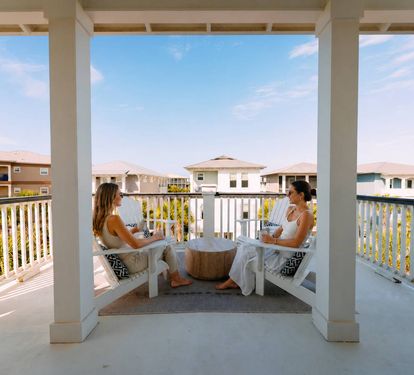 Enjoy morning coffee or sunset drinks on your private balcony with peaceful views of the charming beachside neighborhood. 