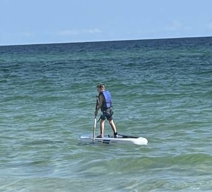 Rent a paddleboard and see the fish and manta rays up close.