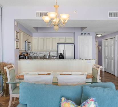 Open dining area w/ chandelier lighting & easy access to the kitchen.