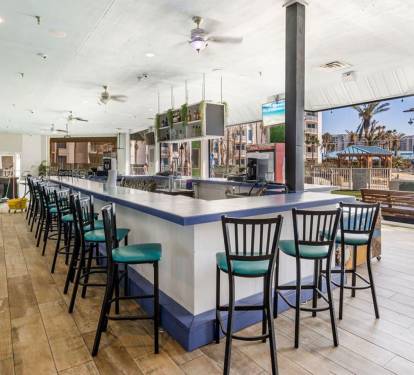 Open-air bar area on-site w/ plenty of seating, TVs, & a laid-back coastal vibe