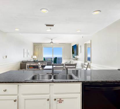 The open concept kitchen, dining and living room is perfect for spending time together as a family.  Bonus - your significant other can watch the waves as they do the dishes!