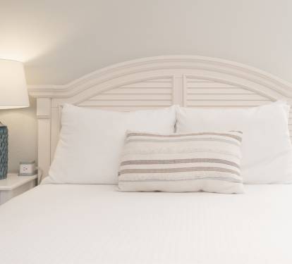 Minimalist bedroom w/ crisp linens and a relaxing atmosphere.