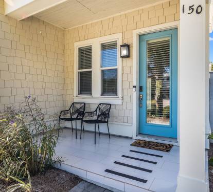 Welcoming front porch with seating and coastal-style entryway.