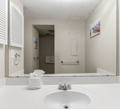 Bathroom w/ a sleek sink for all your needs.