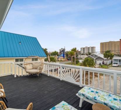 Right outside the game room, you'll find the front balcony, complete with patio seating, egg chair, and lounge chairs.