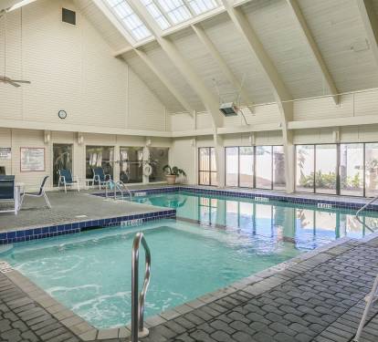 Indoor heated pool.  Please note the extensive sliding glass doors for those beautiful days.  When it is opened up, it is a wonderful open air indoor pool!