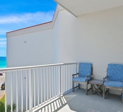 Balcony seating overlooking the sugar-white sand