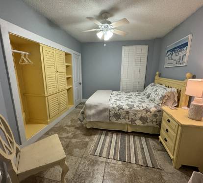 Front bedroom features a queen sized bed with custom built in cabinets with a dumb TV with DishNet service.