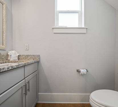 Downstairs half bath with granite vanity and updated fixtures.