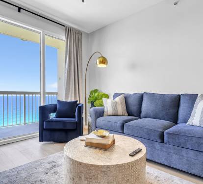 Enjoy a front-row seat to the Gulf from this bright, coastal living space. Comfortable seating, natural light, and direct balcony access create the perfect spot to relax and take in the view.