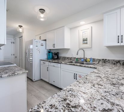 "Whip up your favorite meals in this bright and fully-equipped kitchen, featuring granite countertops and modern appliances. ??? #BeachsideCooking #VacationEats"