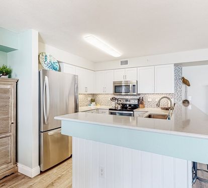 ?? "A Chef’s Dream. This updated kitchen features sleek granite countertops, a stunning tile backsplash, and stainless steel appliances—including a stove, refrigerator, dishwasher, and microwave—perfect for whipping up your favorite meals at After Dune De