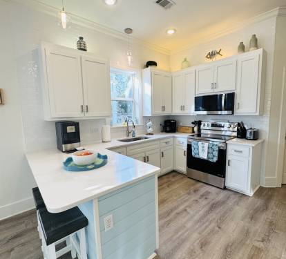 A full laundry room is just beyond the kitchen.