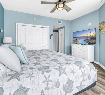 Calm bedroom retreat w/ soft coastal tones, comfy bedding, & TV for laid-back nights
