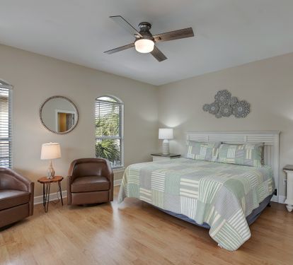King bedroom with ensuite bath and balcony doors