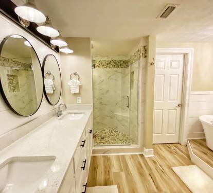 Tile shower, shaker doors, stand alone tub and quartz counters