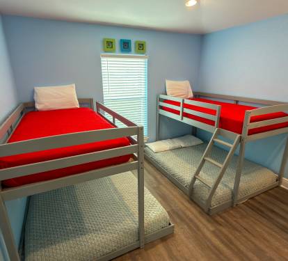 Second Floor Bunk Bedroom 4 is designed with younger guests and groups in mind, featuring two twin-over-full bunks in a bright and cheerful space.