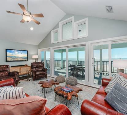 SunScape's Living Room with Vaulted Ceiling Opens to the Deck