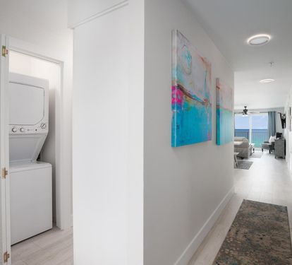 "Welcome to your home away from home! This bright and welcoming entrance also features a convenient in-unit washer and dryer, ensuring your stay is as comfortable and hassle-free as possible. ???? #VacationConvenience #BeachfrontLiving"