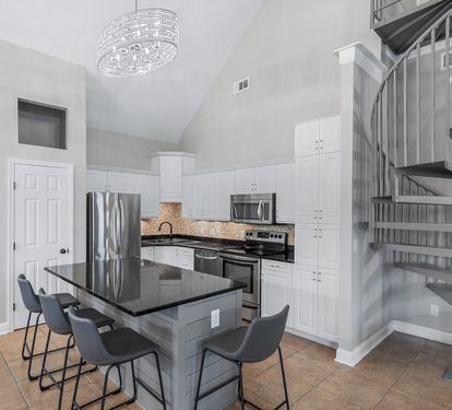 Gourmet kitchen with stainless-steel appliances and breakfast bar seating