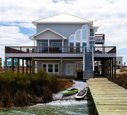 Back of home with private dock and beach faces Lagoon