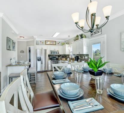 Kitchen with stainless steel appliances. Seats 12 comfortably with table/bar.