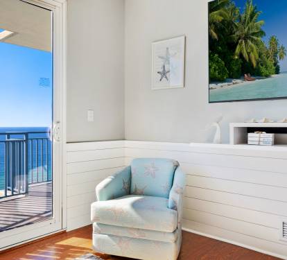 Beach themed swivel captains chairs flanking the TV provide additional living room seating.  And look at the shiplap which begins in the entryway and is carried to the living room.