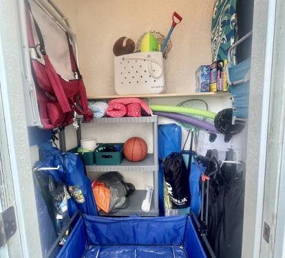 beach closet full of toys, umbrellas, chairs, wagon, tent, etc