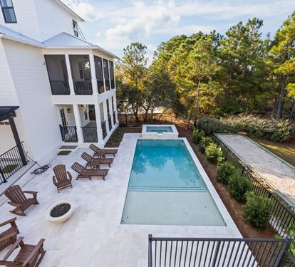 See the whole layout from above — pool, spa, fire bowl, and porches all within a few steps of each other.