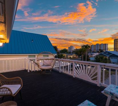 Right outside the game room, you'll find the front balcony, complete with patio seating, egg chair, and lounge chairs.