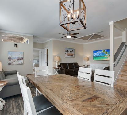 Living room with comfortable seating and coastal artwork