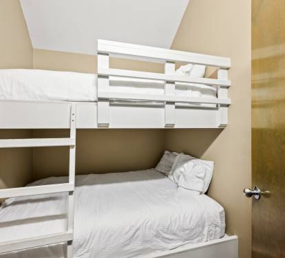 Master bedroom suite on top floor connects to deck and has a bunk room.