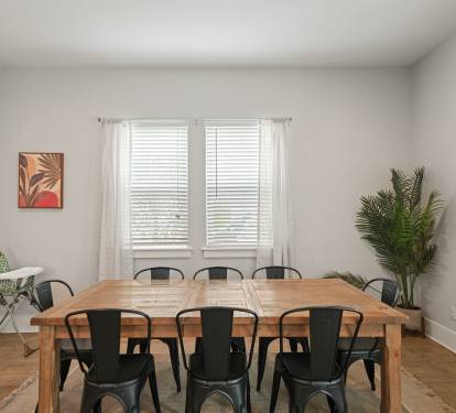 Dining area with large table and seating—perfect for shared meals and gatherings. 