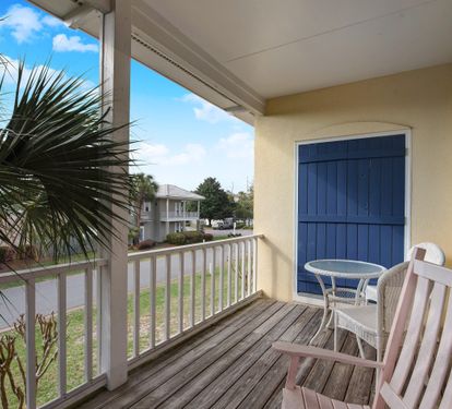 Balcony seating area overlooking palm trees
