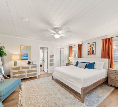 The primary bedroom gives the group leader their own retreat. A king bed, private dressers, armchairs, and arched mirror create a calm
space to come back to after the beach. Have a little one? The pack and plan and extra crib are in the closet!