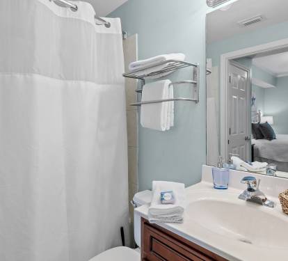 Full bathroom with dual access from both the hallway and the second King bedroom.