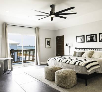 Primary Suite with king bed and private deck with Lagoon and Gulf views