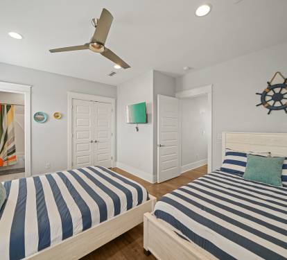 Double Queen Suite featuring two queen beds and coastal-inspired décor.