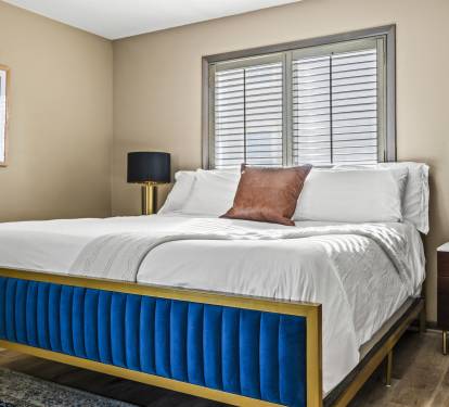 Third king guest bedroom connects to a bathroom and deck.Modern amenities and plenty of storage in this spacious king bedroom. The room is designed for comfort and functionality, featuring amp