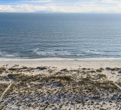 A pristine stretch of sugar-white sand and emerald Gulf waters, framed by natural coastal dunes—this private Kiva Dunes beach access offers a peaceful, uncrowded setting that feels worlds away from the typical crowded shoreline.