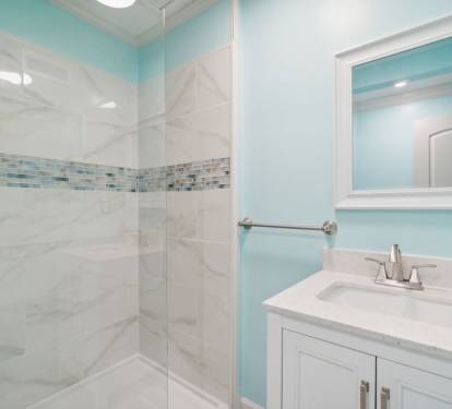 Right outside the queen bedroom, a full bathroom with a walk in shower.