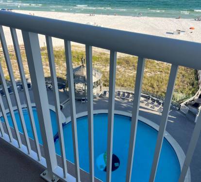 View of pool and beach from balcony