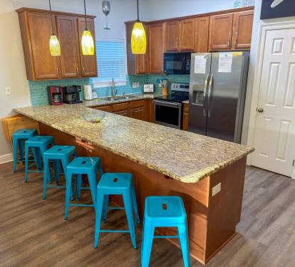 Created for entertaining, the kitchen features generous seating, modern stainless-steel appliances, and a spacious pantry for convenience.