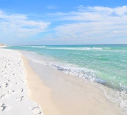 Soft white-sand beach w/ gentle waves and wide open shoreline for long, relaxing walks.